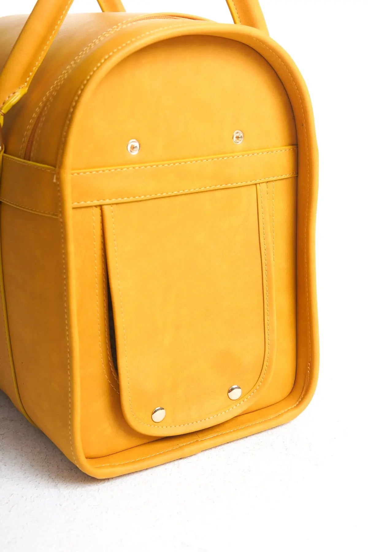 Close-up of the back of the Kelly Airline Approved Pet Travel Carrier Bag in Mustard by PAW LONDON, detailing the sophisticated stitching and functional design for pet travel.