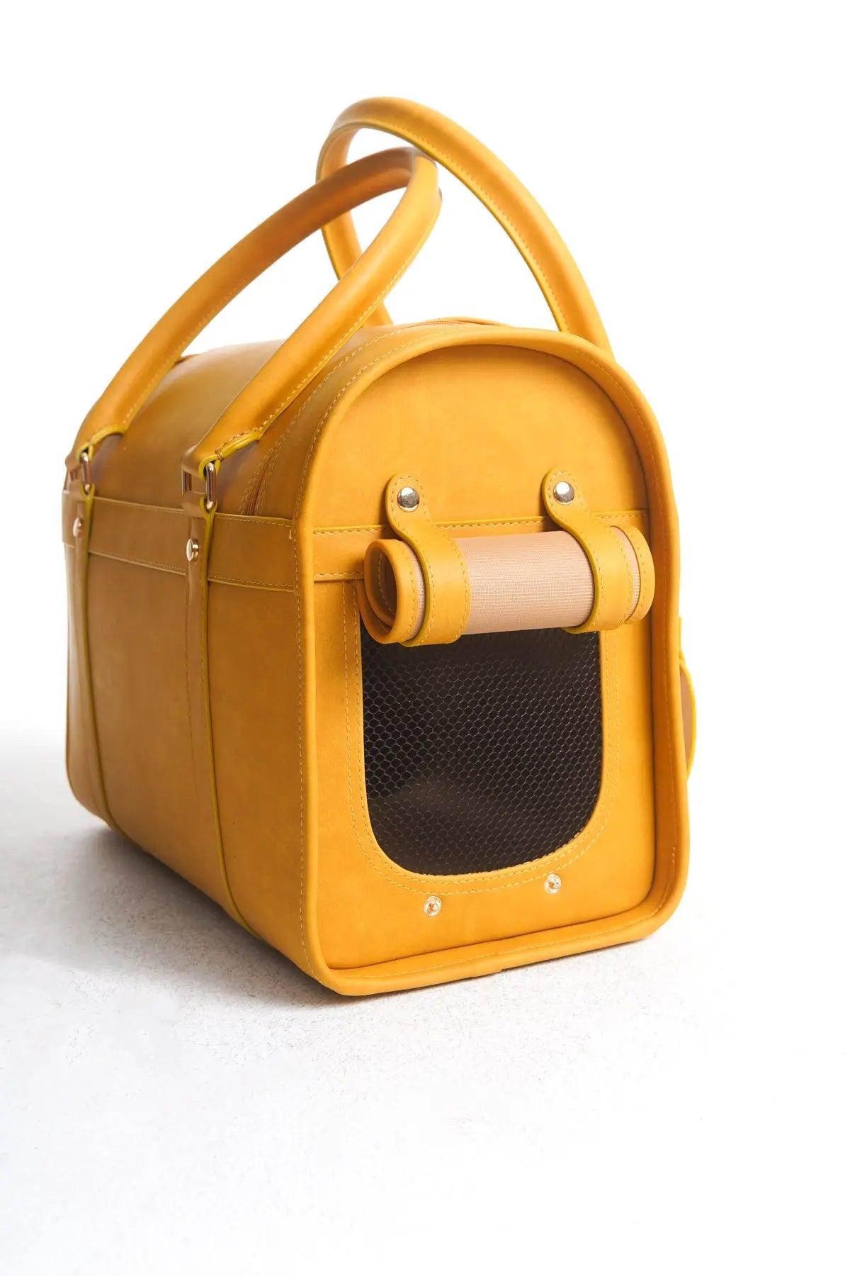 Side view of the Kelly Airline Approved Pet Travel Carrier Bag in Mustard by PAW LONDON, illustrating the chic design and practical features for airline-approved pet carriers.