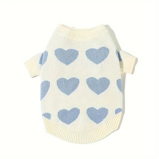 a white sweater with n blue hearts on it