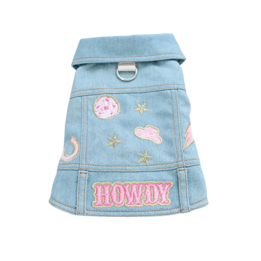 a small dog denim jacket with patches and stars on it