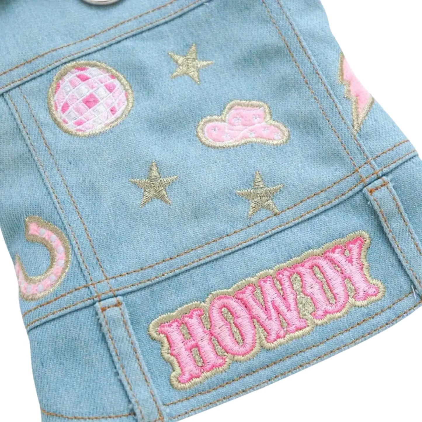 a close up of a denim dog jacket with patches on it