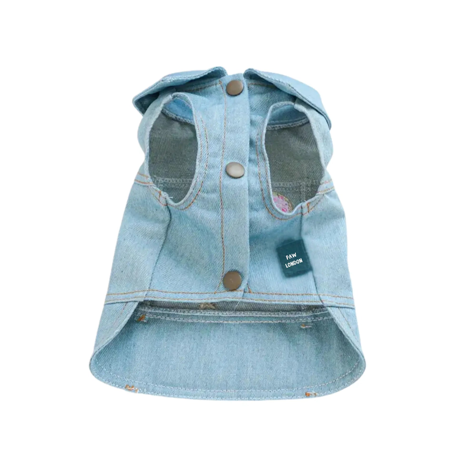 a dog wearing a jean jacket with a tag on it