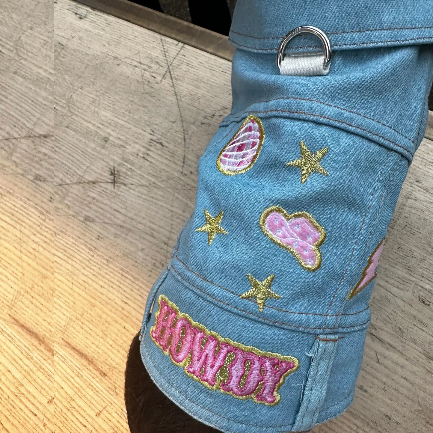 a close up of a denim jacket with patches on them